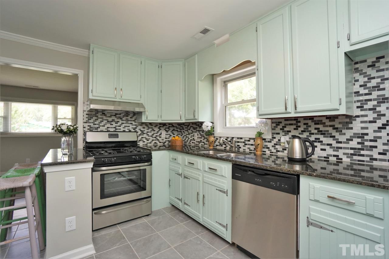 700 Darby Street Raleigh, NC 27610 - Photo 2 of 23 a kitchen with granite countertop white cabinets and white appliances