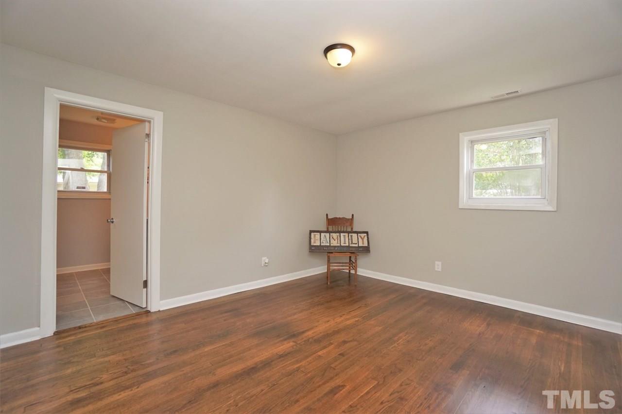 700 Darby Street Raleigh, NC 27610 - Photo 13 of 23 a view of an empty room with a window and wooden floor