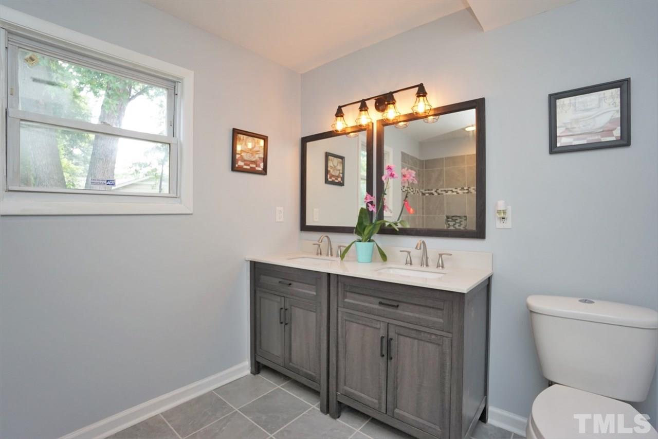 700 Darby Street Raleigh, NC 27610 - Photo 14 of 23 a bathroom with a toilet a sink and mirror