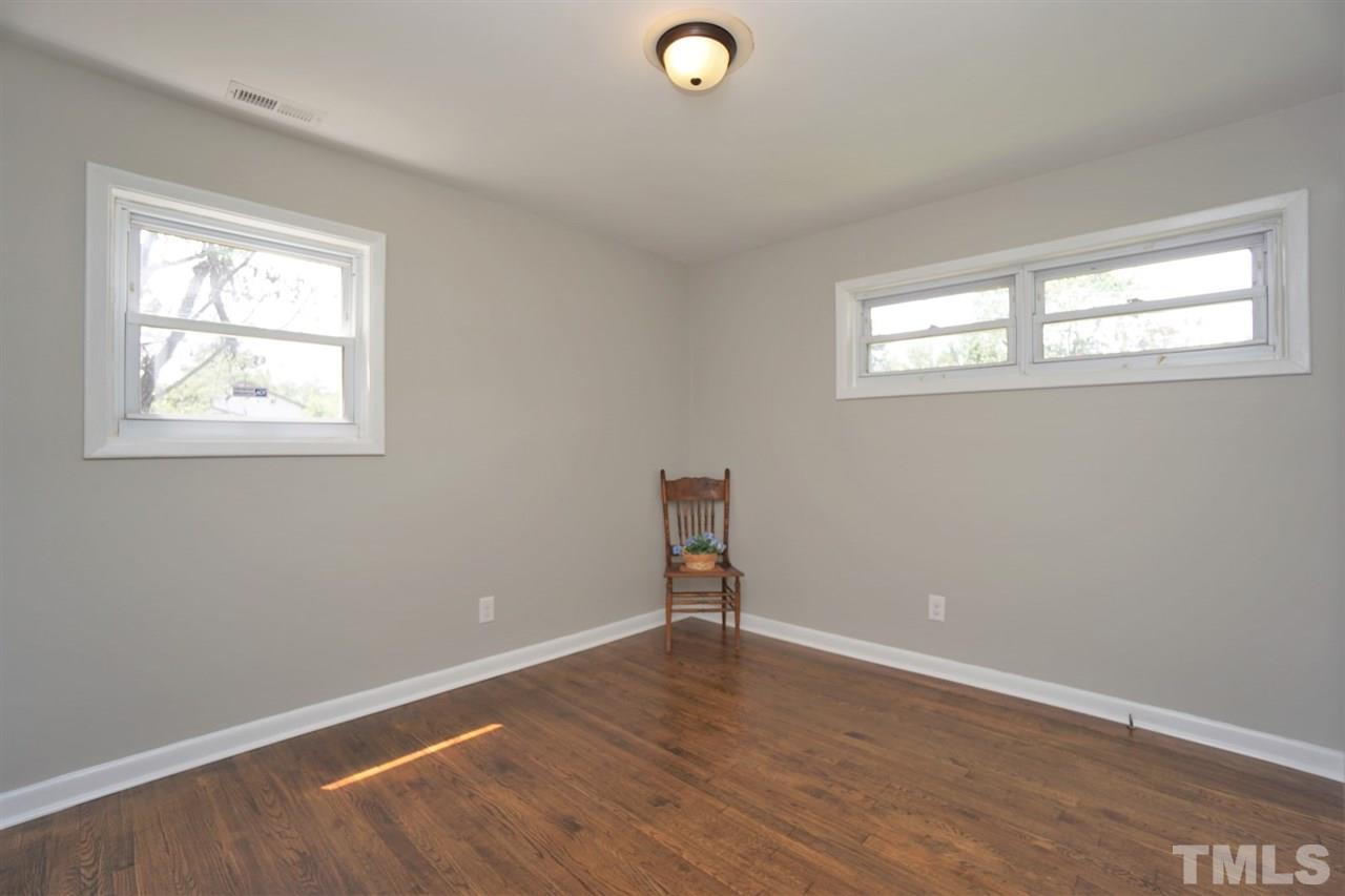 700 Darby Street Raleigh, NC 27610 - Photo 17 of 23 an empty room with wooden floor and windows