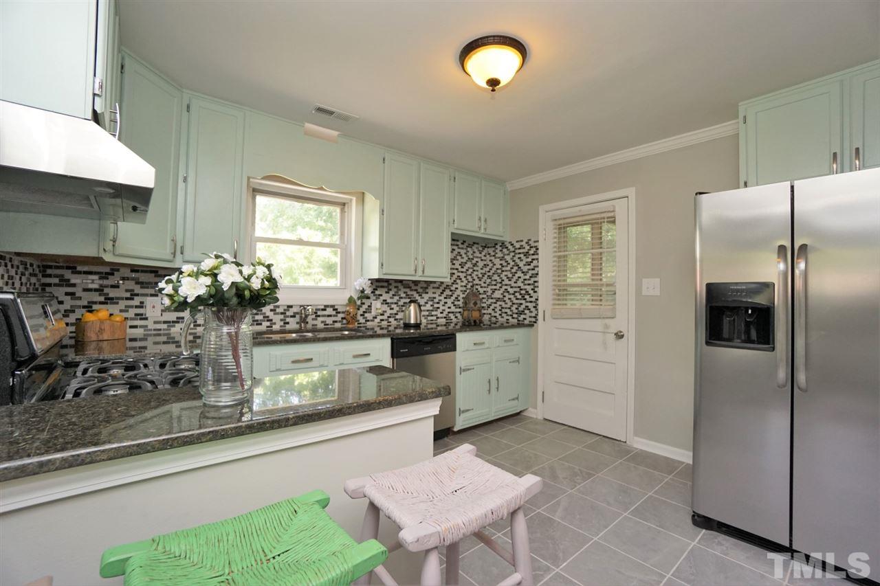 700 Darby Street Raleigh, NC 27610 - Photo 3 of 23 a kitchen with stainless steel appliances kitchen island granite countertop a refrigerator and stove