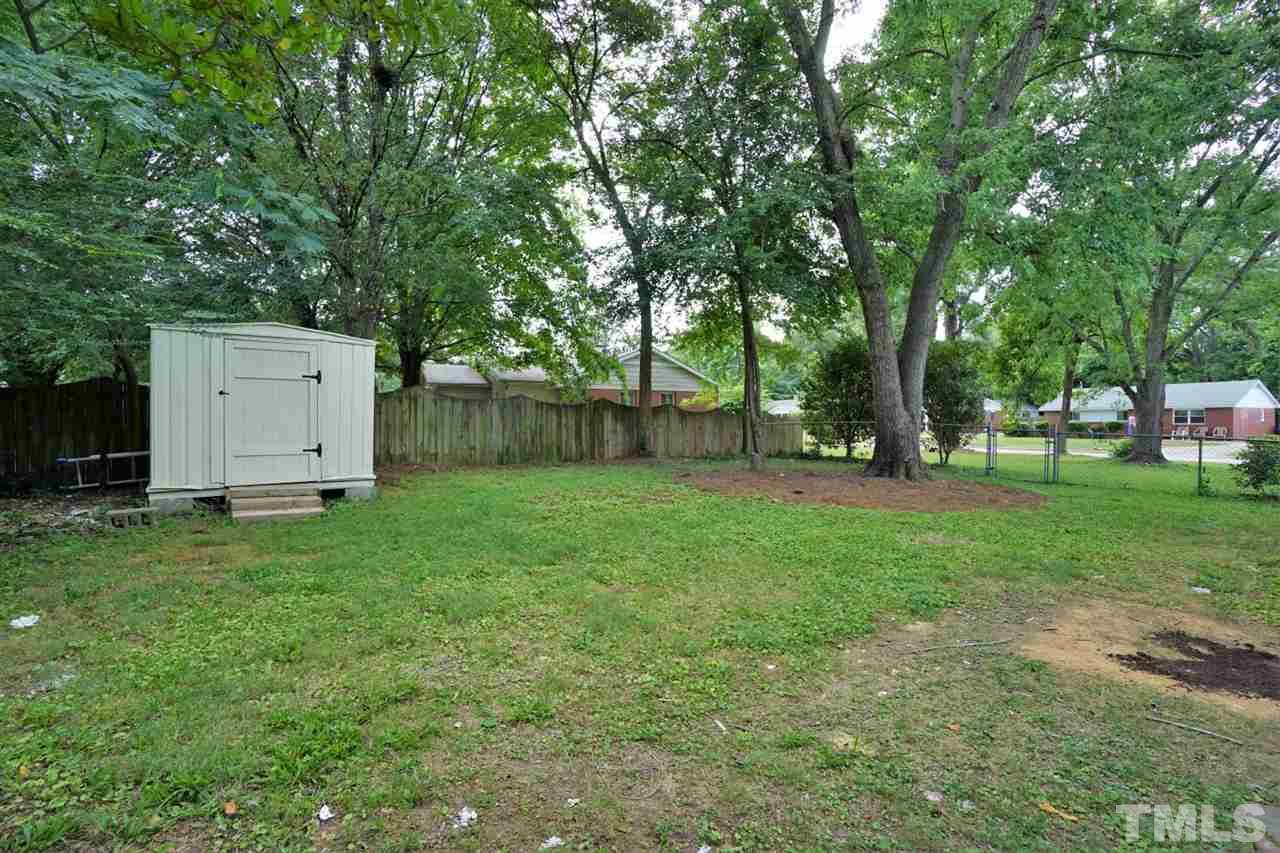 700 Darby Street Raleigh, NC 27610 - Photo 22 of 23 a backyard of a house with plants and large tree