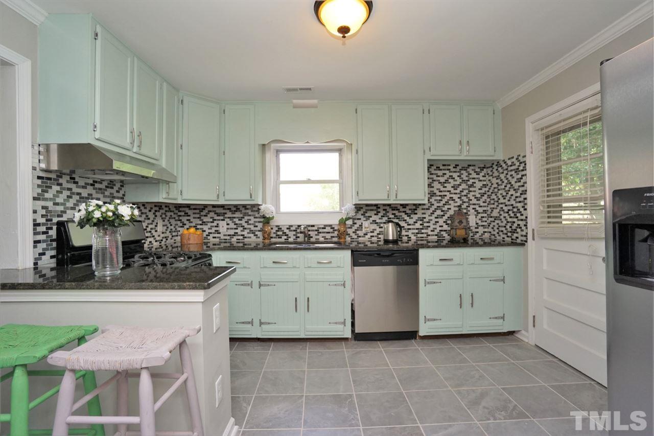 700 Darby Street Raleigh, NC 27610 - Photo 4 of 23 a kitchen with granite countertop a sink and cabinets