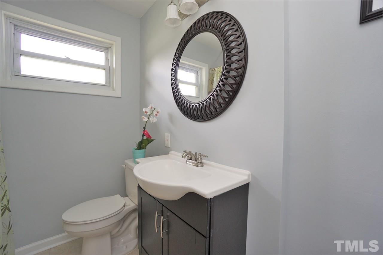 700 Darby Street Raleigh, NC 27610 - Photo 7 of 23 a bathroom with a sink a mirror and a toilet