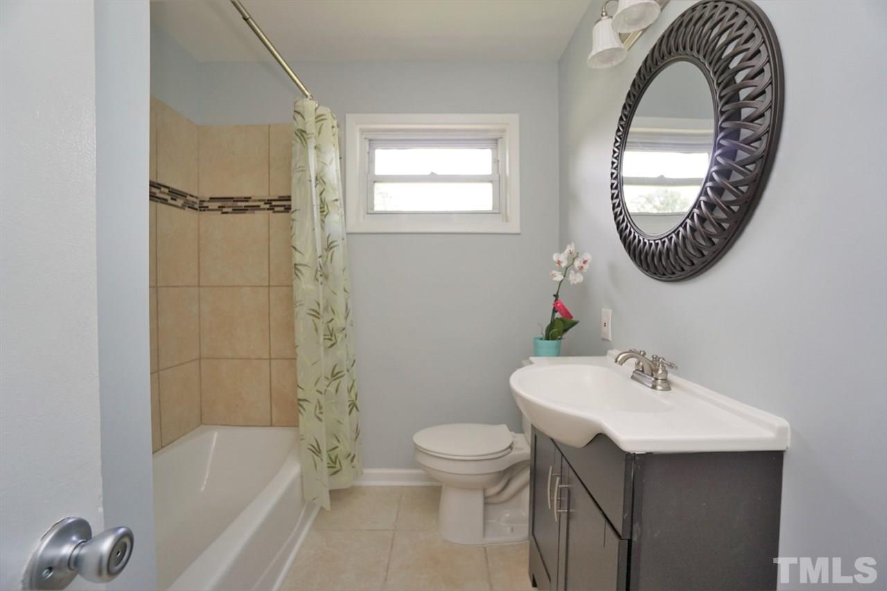 700 Darby Street Raleigh, NC 27610 - Photo 8 of 23 a bathroom with a sink a toilet and a bathtub