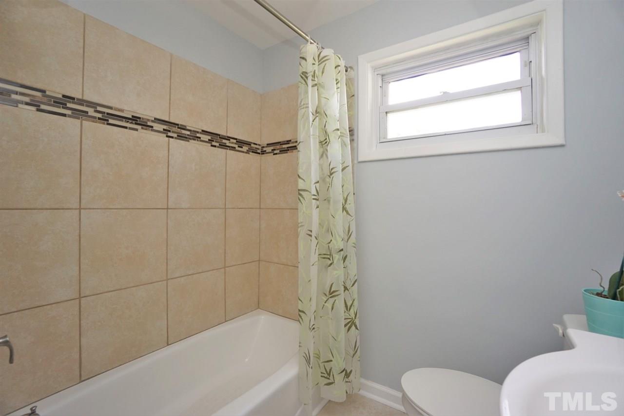 700 Darby Street Raleigh, NC 27610 - Photo 9 of 23 a bathroom with a toilet and shower