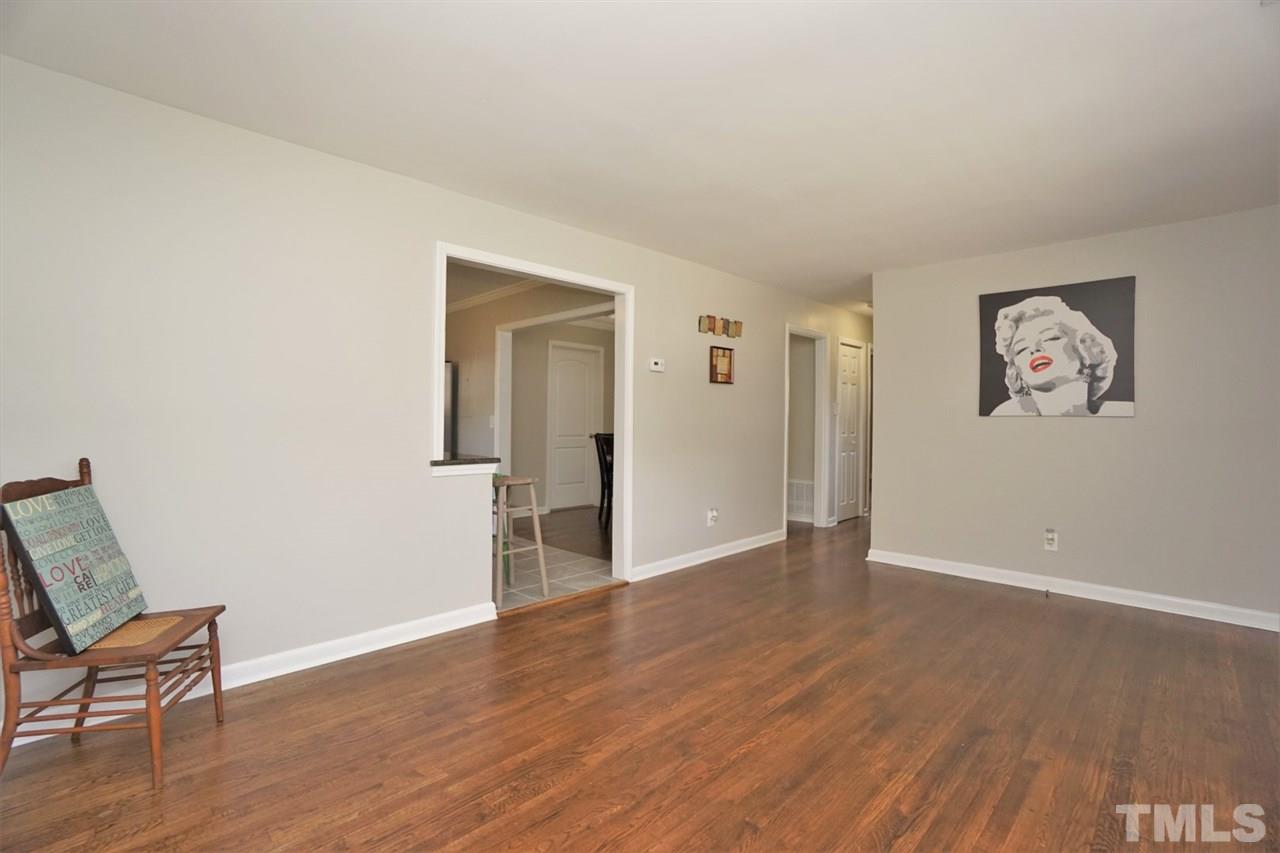 700 Darby Street Raleigh, NC 27610 - Photo 10 of 23 a view of an empty room with wooden floor and a window
