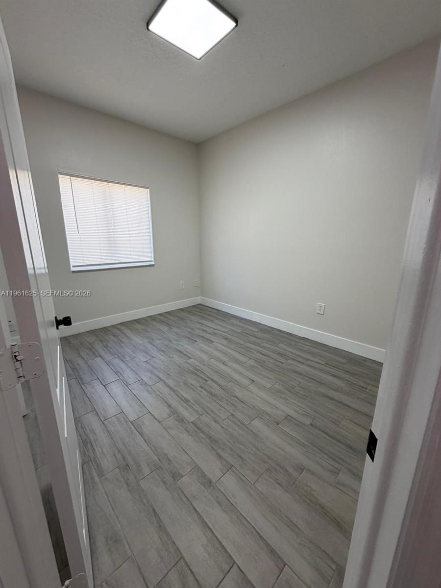5521 Southwest 158th Court Miami, FL 33185 - Photo 12 of 23 an empty room with wooden floor and windows