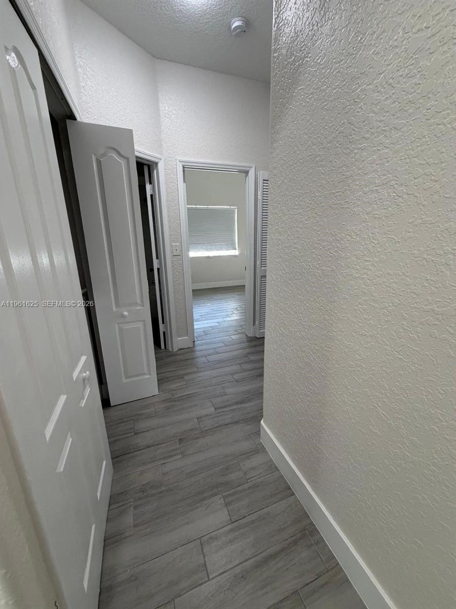 5521 Southwest 158th Court Miami, FL 33185 - Photo 13 of 23 a view of a hallway with wooden floor