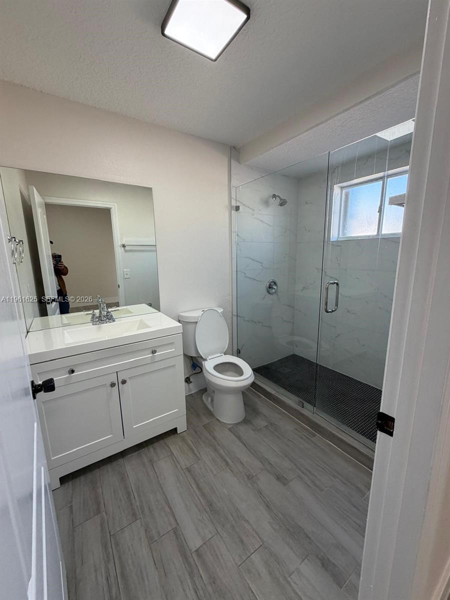 5521 Southwest 158th Court Miami, FL 33185 - Photo 15 of 23 a bathroom with a double vanity sink toilet and shower