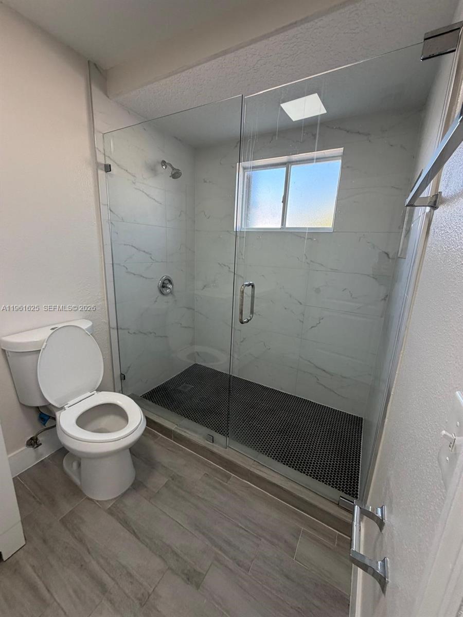 5521 Southwest 158th Court Miami, FL 33185 - Photo 16 of 23 a bathroom with a toilet and a shower