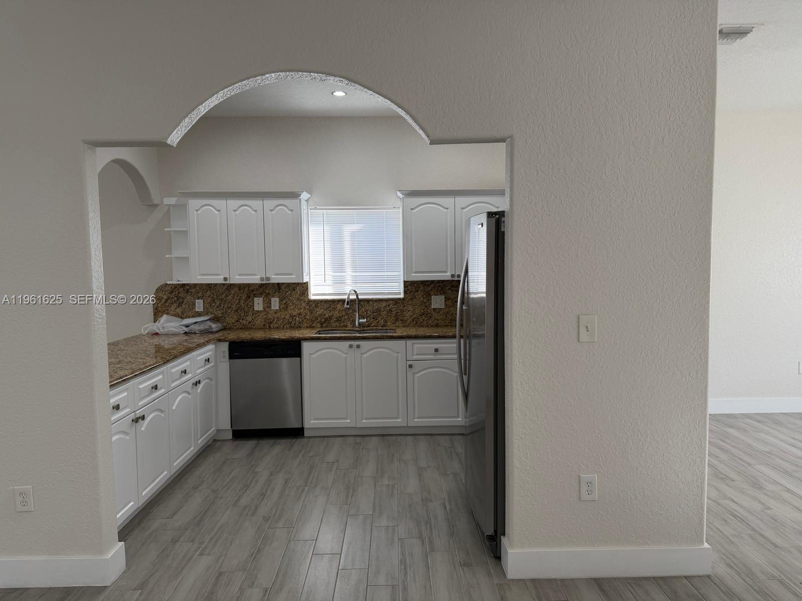 5521 Southwest 158th Court Miami, FL 33185 - Photo 18 of 23 a kitchen with granite countertop white cabinets and white appliances