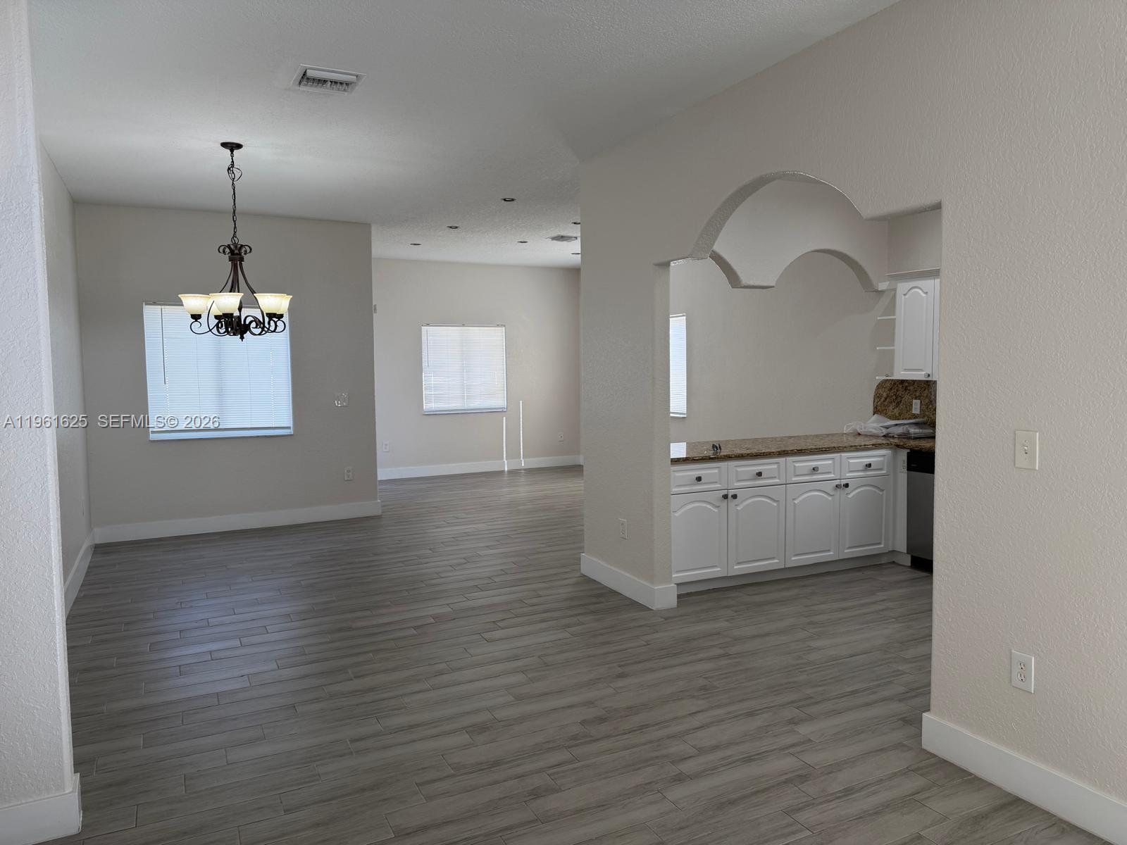 5521 Southwest 158th Court Miami, FL 33185 - Photo 3 of 23 a view of a kitchen with a dishwasher cabinets and a wooden floor