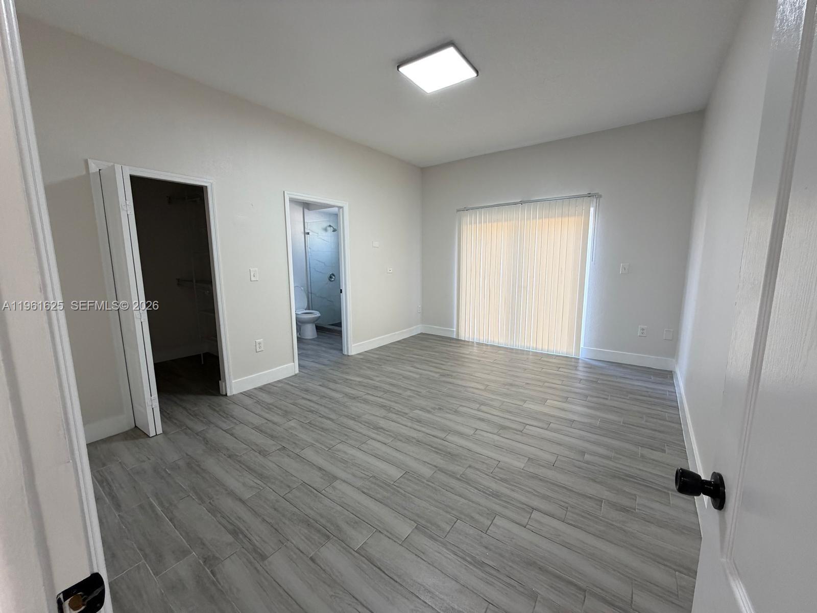 5521 Southwest 158th Court Miami, FL 33185 - Photo 8 of 23 an empty room with wooden floor and closet
