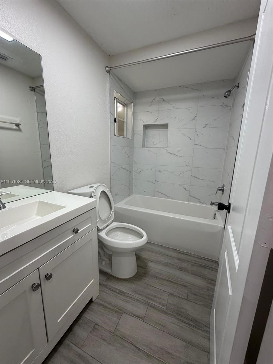 5521 Southwest 158th Court Miami, FL 33185 - Photo 9 of 23 a bathroom with a toilet a sink and bathtub