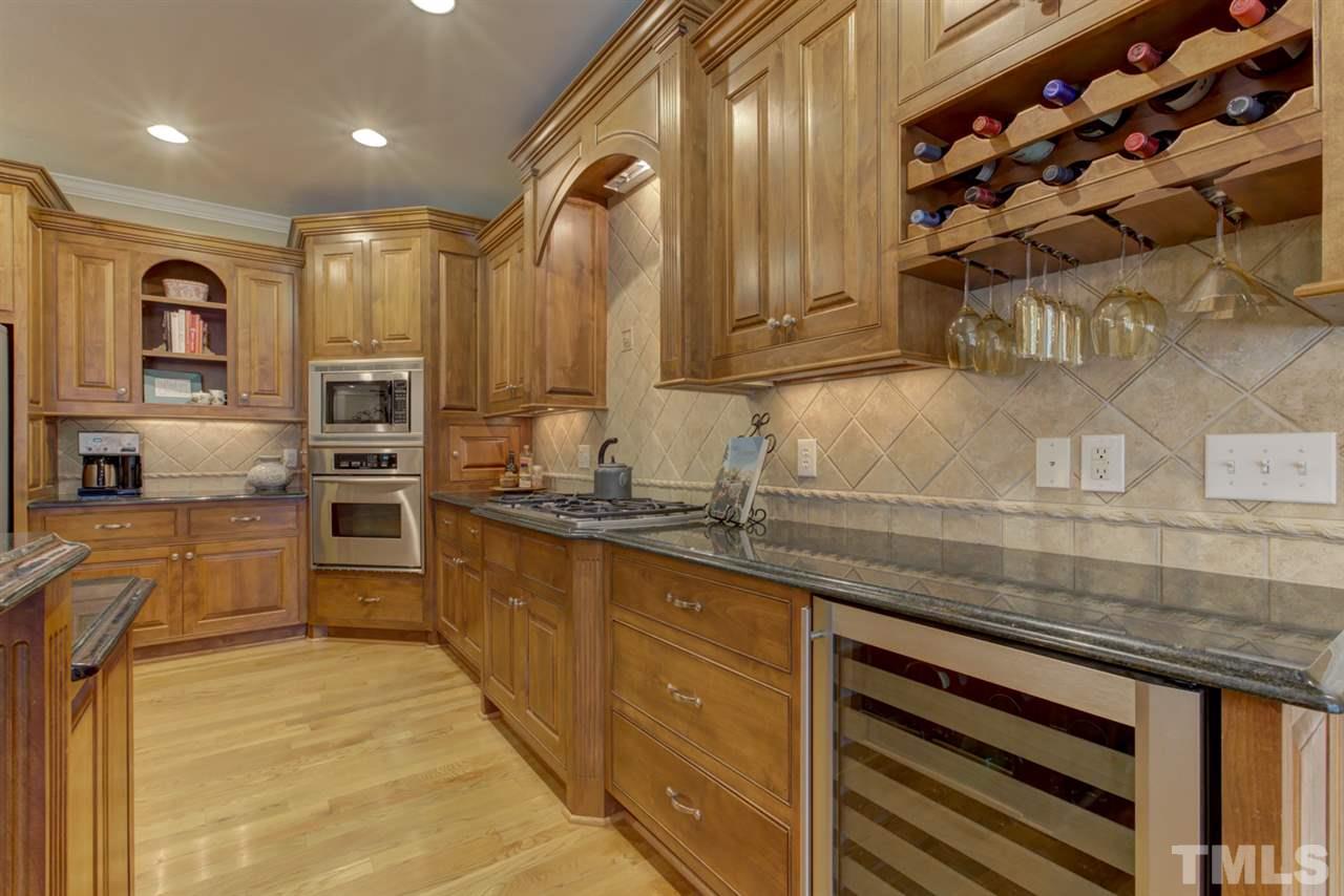 1009 Quiet Ridge Circle Raleigh, NC 27614 - Photo 11 of 30 This view of kitchen highlights beautiful cabinetry including wine rack