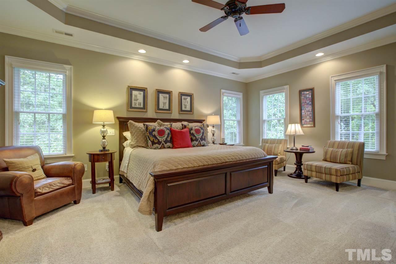 1009 Quiet Ridge Circle Raleigh, NC 27614 - Photo 14 of 30 Huge Master Bedroom with plenty of space for sitting area. Elegant Tray Ceiling and recessed lights. Beautiful views from master bedroom of private, wooded lot