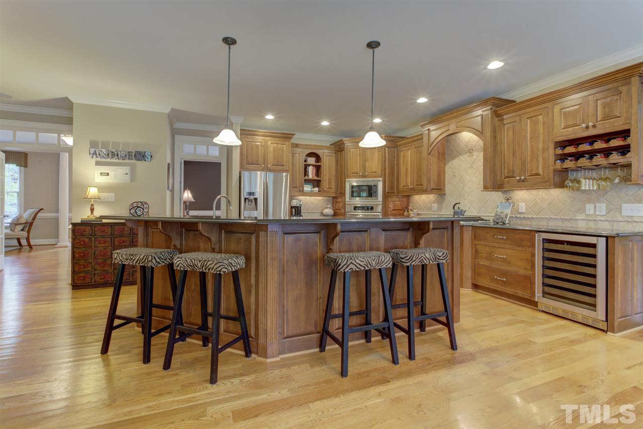 1009 Quiet Ridge Circle Raleigh, NC 27614 - Photo 9 of 30 Huge Gourmet Kitchen with high end custom cabinets, granite and tile back splash