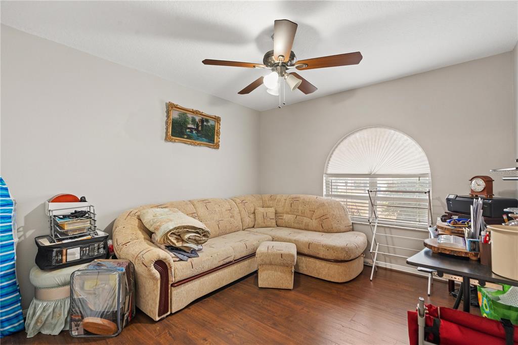 7466 Apache Trail Spring Hill, FL 34606 - Photo 16 of 27 a living room with furniture and a wooden floor