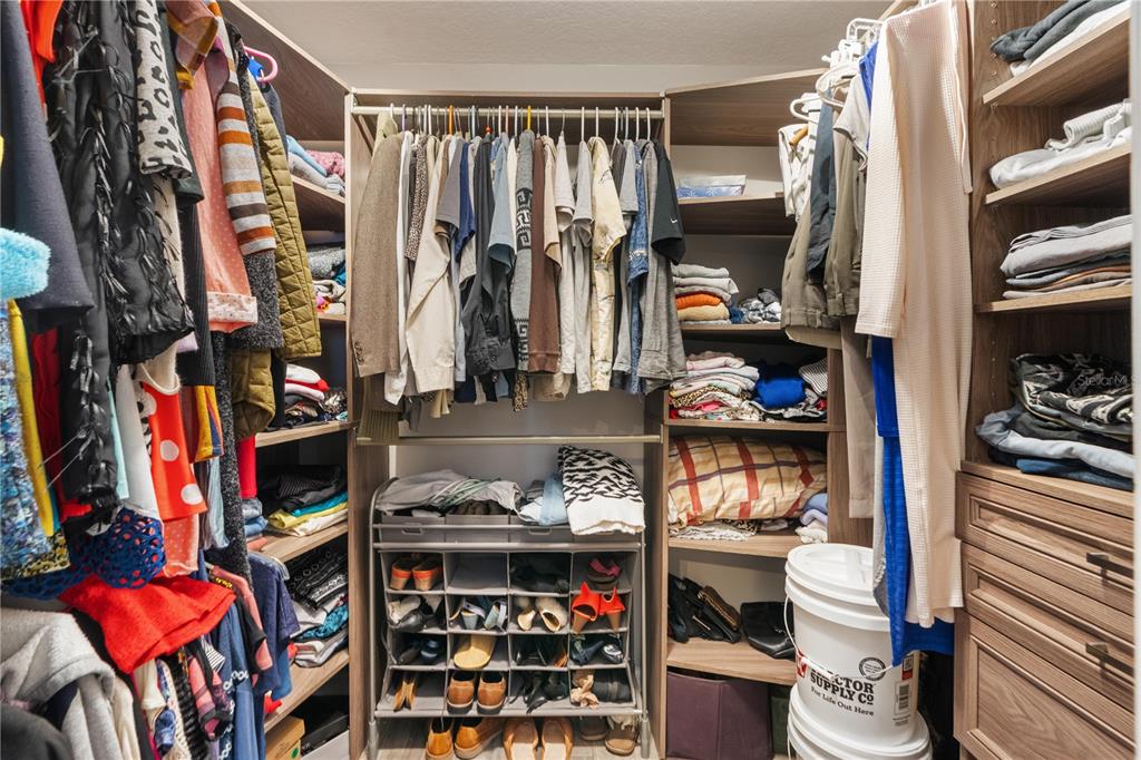 7466 Apache Trail Spring Hill, FL 34606 - Photo 20 of 27 a view of walk in closet with clothes and shoes