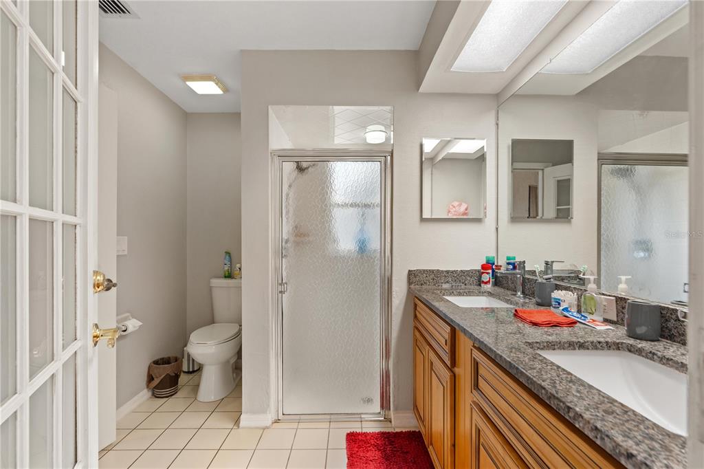 7466 Apache Trail Spring Hill, FL 34606 - Photo 22 of 27 a bathroom with a granite countertop sink mirror vanity and toilet