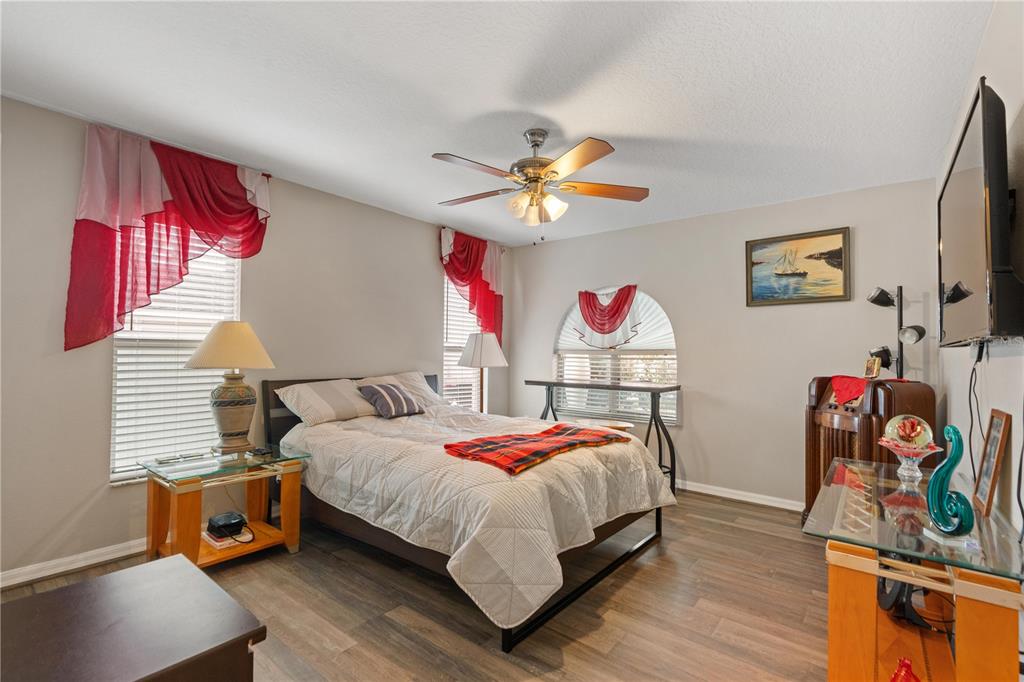 7466 Apache Trail Spring Hill, FL 34606 - Photo 23 of 27 a bedroom with a bed and a chandelier