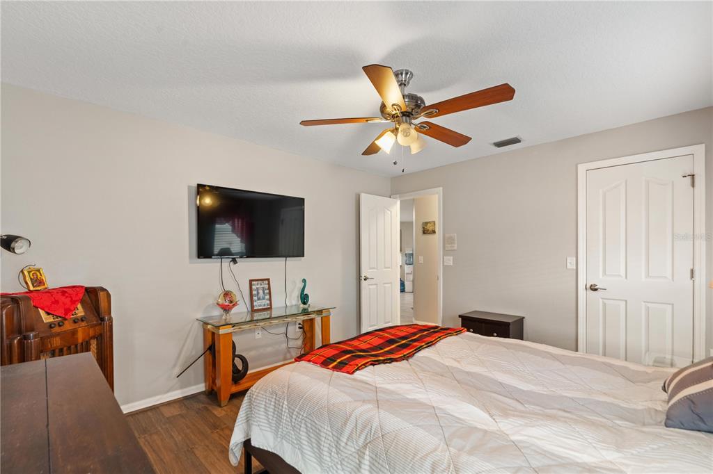 7466 Apache Trail Spring Hill, FL 34606 - Photo 24 of 27 a bedroom with a bed and a flat screen tv