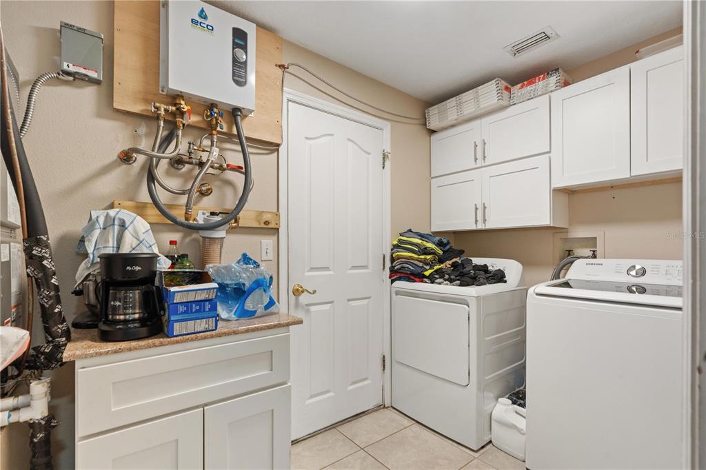 7466 Apache Trail Spring Hill, FL 34606 - Photo 25 of 27 a kitchen with a stove and a white refrigerator
