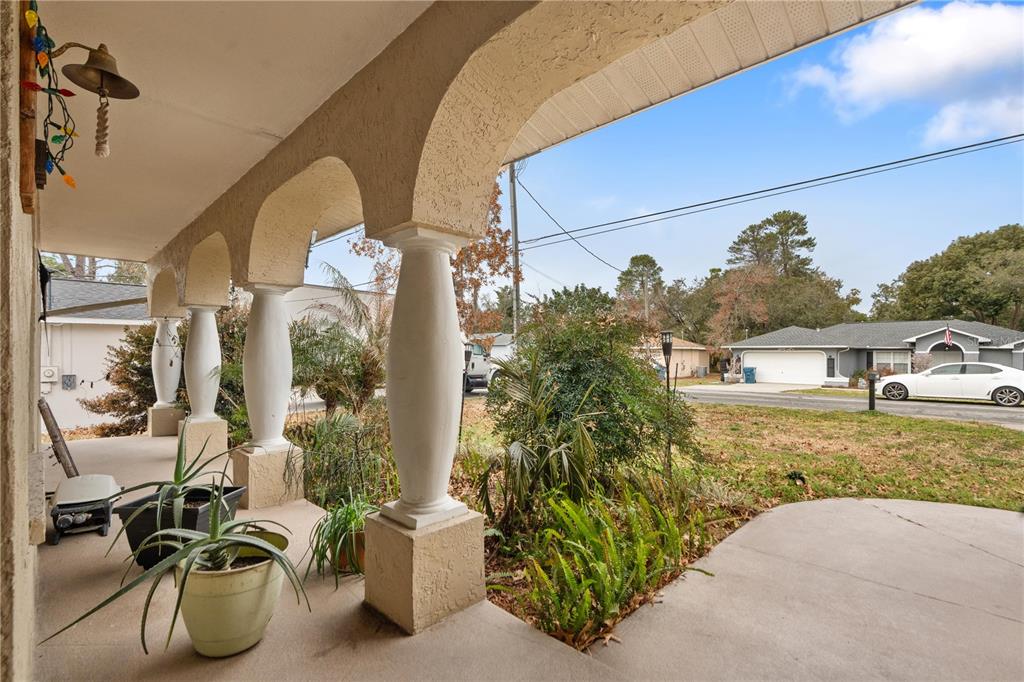 7466 Apache Trail Spring Hill, FL 34606 - Photo 3 of 27 a front view of a house with garden
