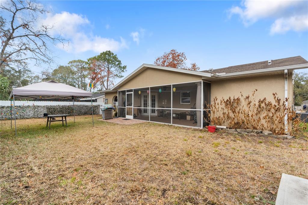 7466 Apache Trail Spring Hill, FL 34606 - Photo 6 of 27 a view of a house with a yard
