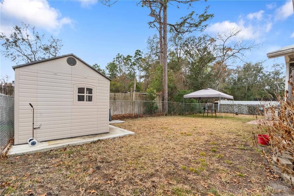 7466 Apache Trail Spring Hill, FL 34606 - Photo 7 of 27 a house view with a backyard space