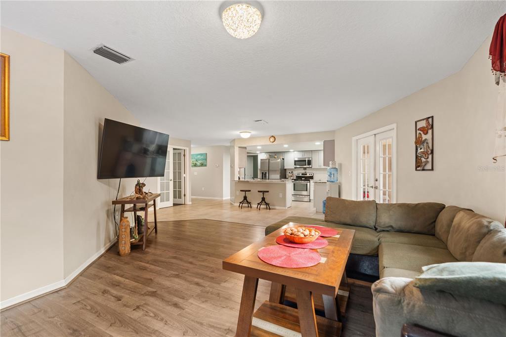 7466 Apache Trail Spring Hill, FL 34606 - Photo 10 of 27 a living room with furniture and a flat screen tv