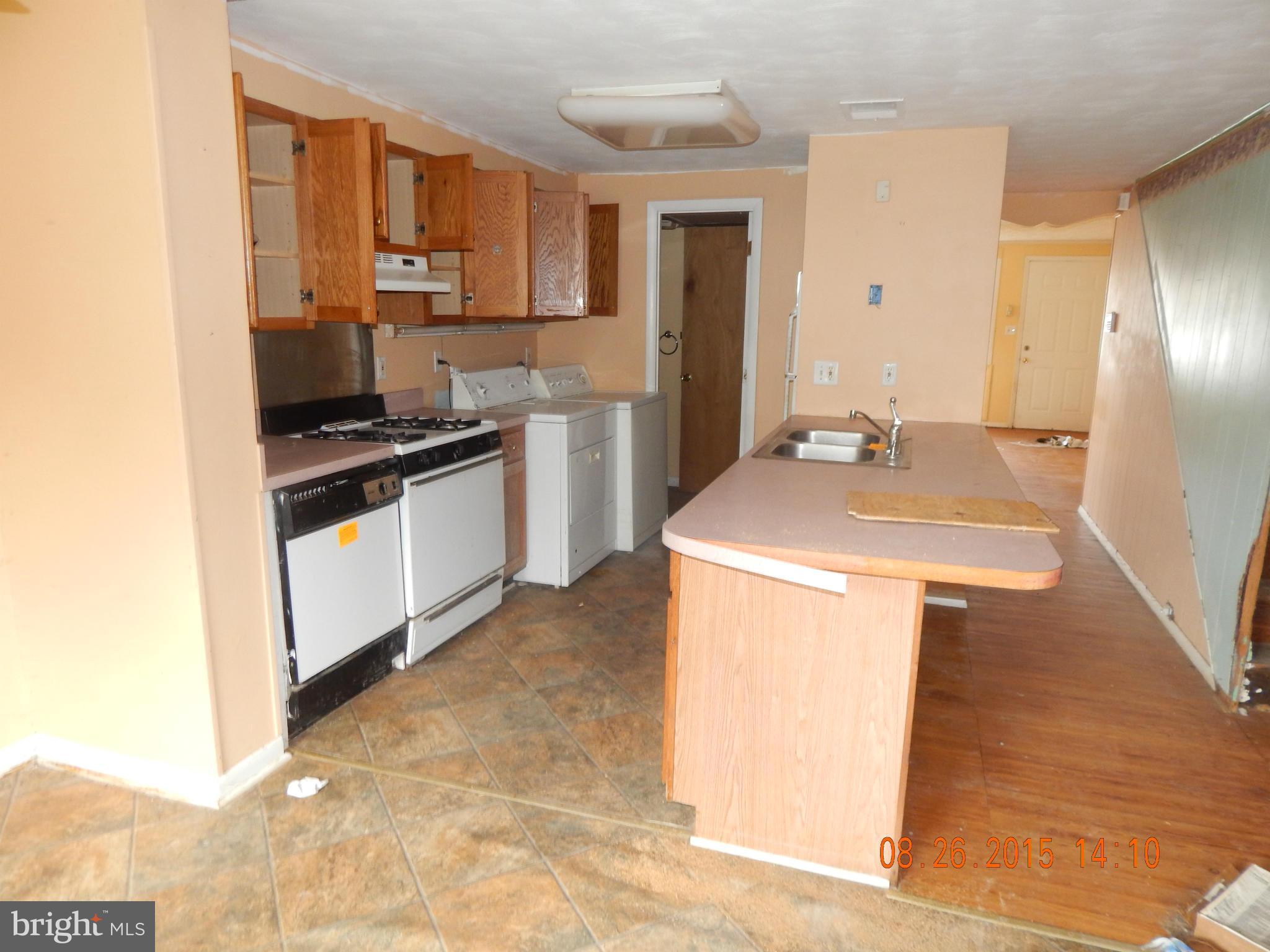 2757 Yarnall Road Baltimore, MD 21227 - Photo 2 of 11 a kitchen with stainless steel appliances granite countertop a sink stove and refrigerator