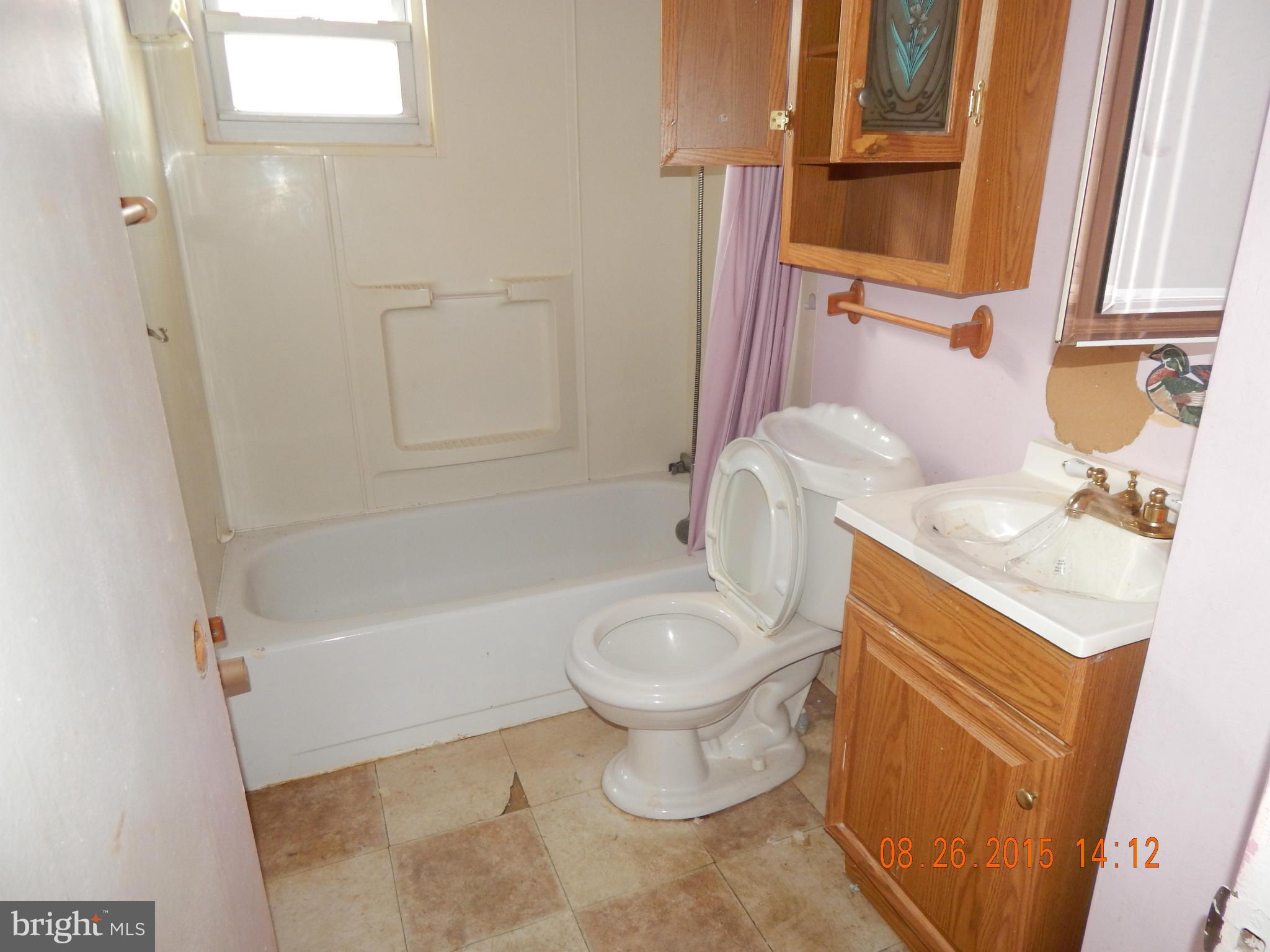 2757 Yarnall Road Baltimore, MD 21227 - Photo 3 of 11 a bathroom with a sink toilet and shower