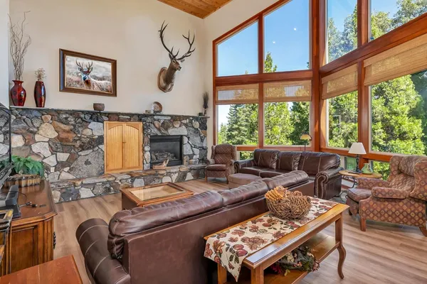 a living room with furniture and a floor to ceiling window