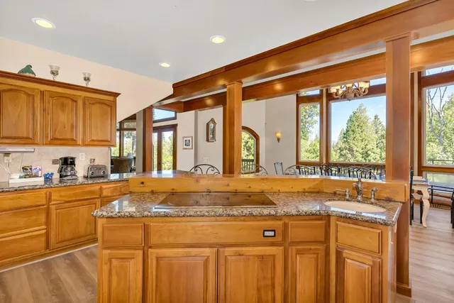 a kitchen with stainless steel appliances granite countertop a stove a sink and a refrigerator