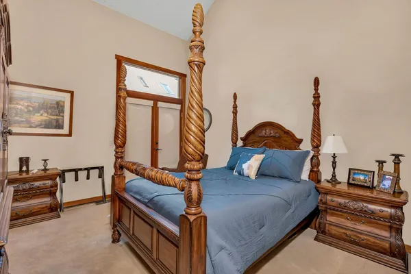 a bedroom with a bed and a chandelier