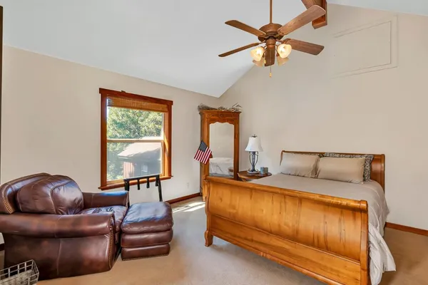 a bedroom with furniture and a chandelier