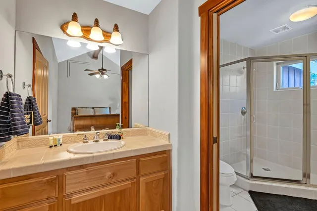 a bathroom with a sink vanity and a mirror