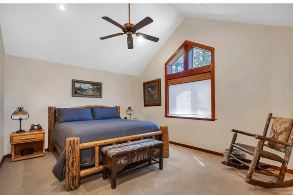 a bedroom with a bed and a chandelier