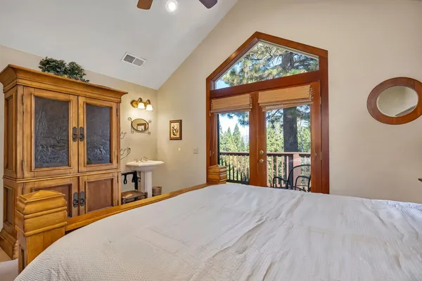 a bedroom with a large bed and a large window