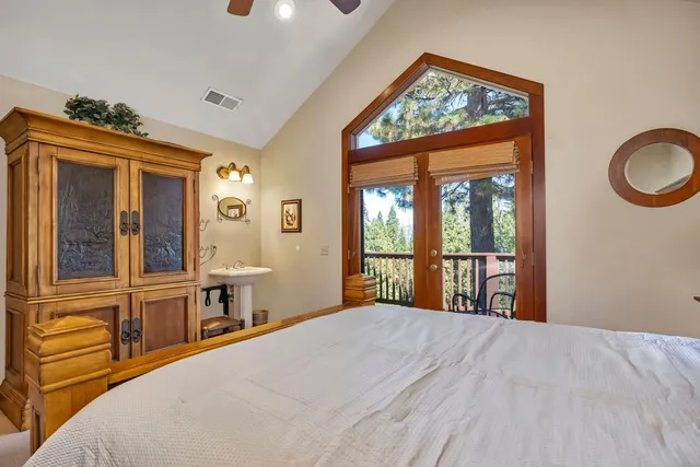 a bedroom with a large bed and a large window