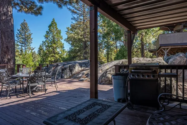 a view of a patio with table and chairs and wooden floor