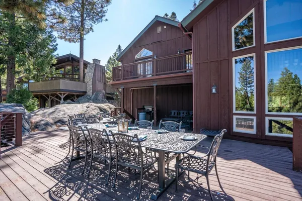 a view of a patio with table and chairs and wooden floor