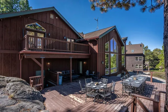 a view of a house with backyard porch and sitting area