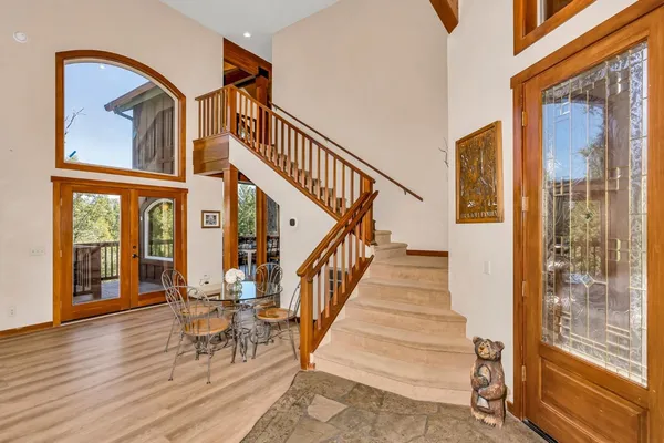 a view of staircase with large window and wooden floor