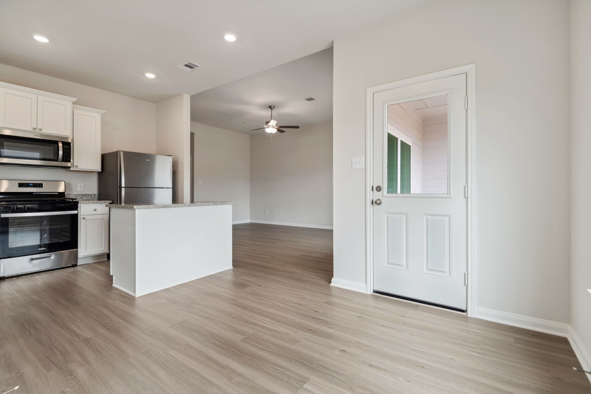 356 Fastboy Lane Waller, TX 77484 - Photo 11 of 23 a view of a kitchen with wooden floor electronic appliances and stairs