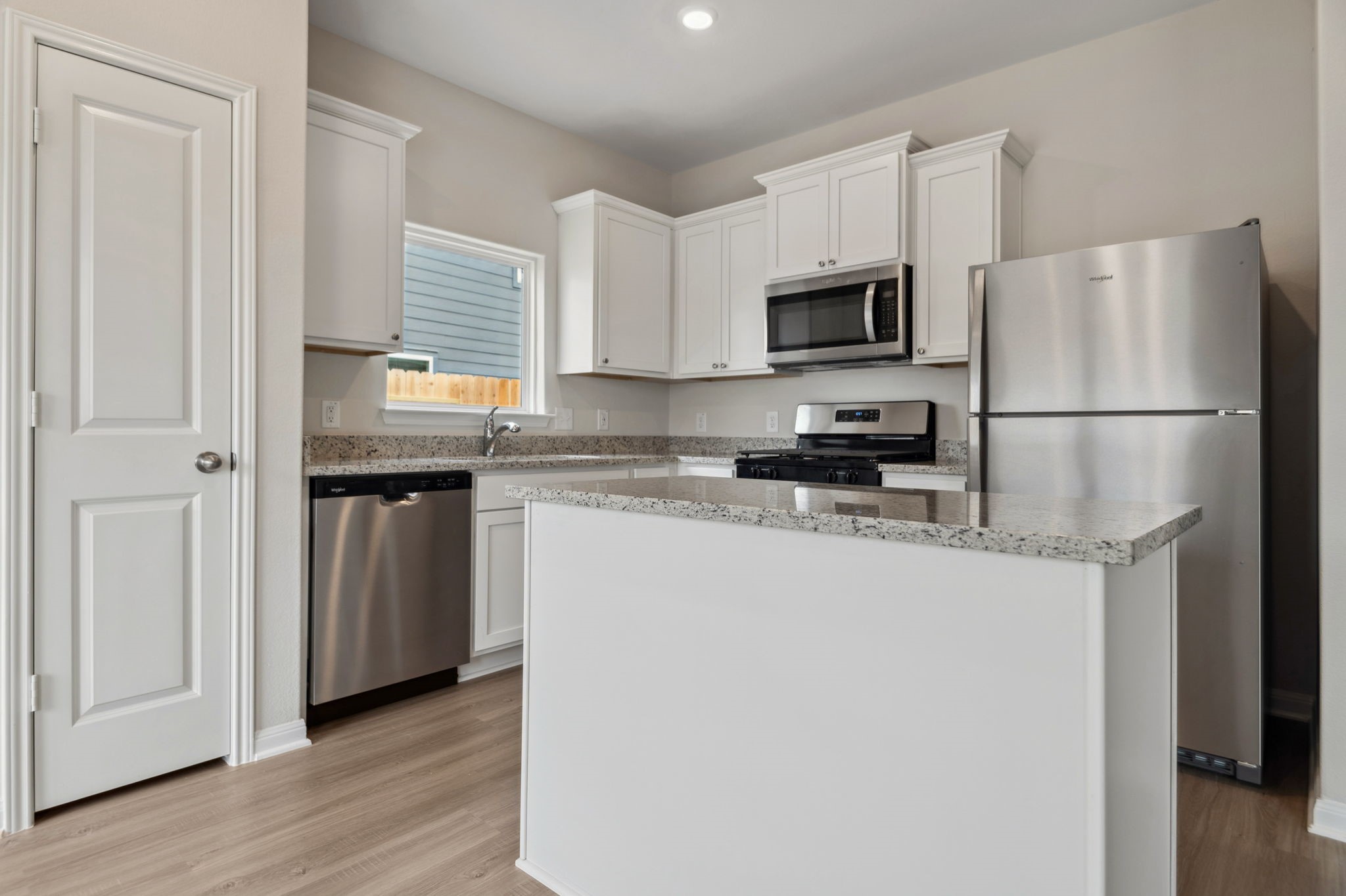356 Fastboy Lane Waller, TX 77484 - Photo 13 of 23 a kitchen with stainless steel appliances a refrigerator a sink a stove a microwave and cabinets