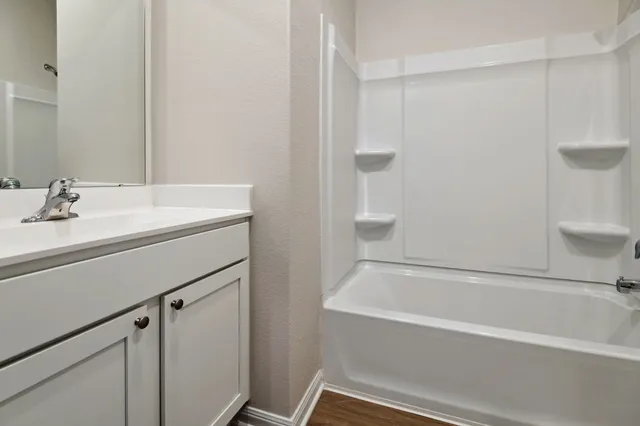 a bathroom with a bathtub and a sink