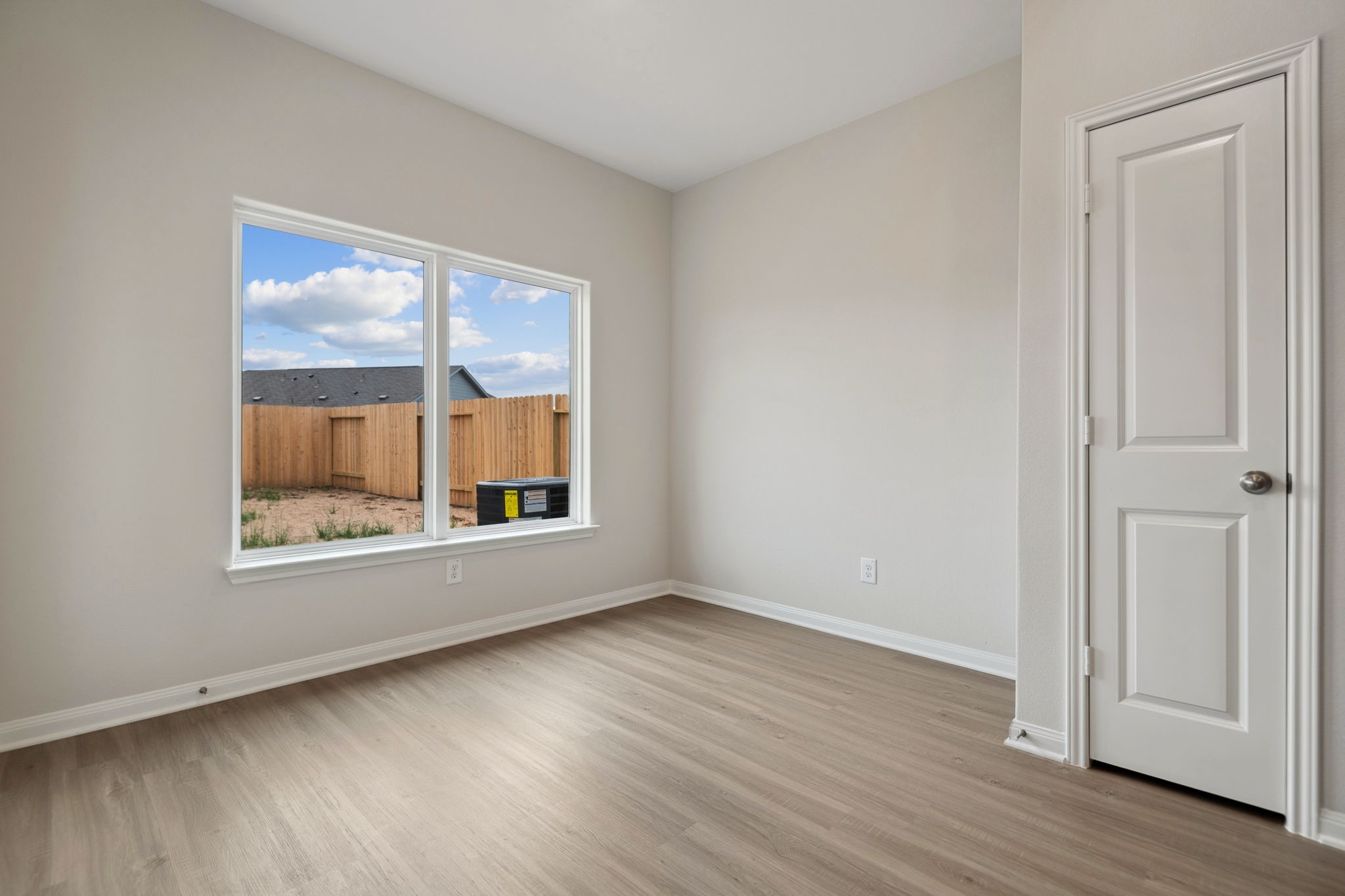 356 Fastboy Lane Waller, TX 77484 - Photo 10 of 23 an empty room with wooden floor and windows